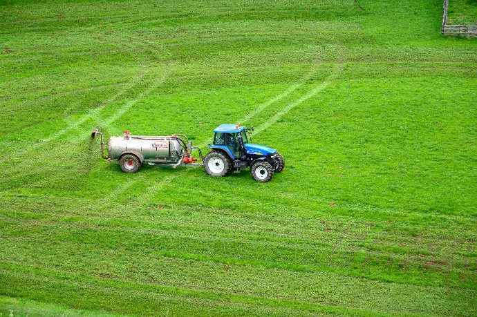 brown tractor on green grass field
